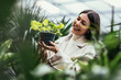 © Mediteraneo - Young woman buying flowers at a garden center