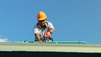 Wall Mural - Senior male engineer wearing safety helmet boarding an aerial work platform inspecting modern solar panel systems for safety with electric drill tools to install solar panels on very high structures.