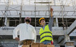 © Jack Tamrong - Engineer Construction man showing Arab businessman developing project in construction site