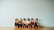 © Flamingo Images - Smiling young friends sitting in a gym after yoga class