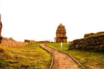 Ancient rock cut Shiva temple (Lower Shivalaya) during sunset, with beautiful stone cladded pathway.