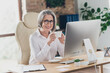 © deagreez - Photo of smiling charming assistant lady wear spectacles white shirt drinking tea having working pause indoors workplace workshop