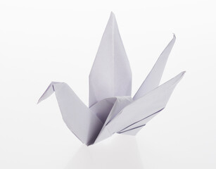 Wall Mural - White origami paper crane on white background