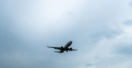 Canvas Print - Background of airplane flying in overcast sky