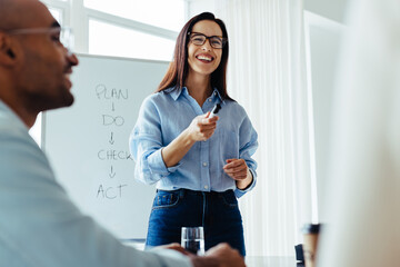 Poster - Happy business woman discussing with her team in a meeting