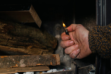 man lighting a fireplace in the house