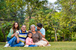 © Niks Ads - Happy indian or asian family sitting at park.