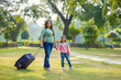 © Niks Ads - Indian mother and her little girl with suitcases. ready for travel