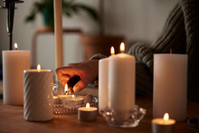 Woman Lighting Candles At Home