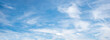 wide sky panorama with feathery clouds on blue background