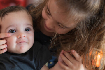 Two cute little sisters having a good time at home