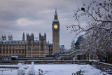Fototapeta Londyn - The snow covered Big Ben clocktower at Westminster Bridge, London, England, on a cold winter morning
