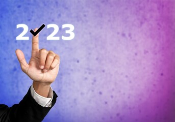 Sticker - Businessman hand pointing on 2023 icon