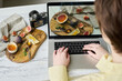 Close-up of young graphic designer retouching professional photos of still life on laptop