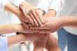 © New Africa - Group of people holding hands together indoors, closeup. Unity concept