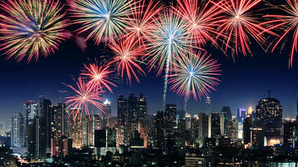 Wall Mural - Amazing beautiful colorful fireworks display on celebration night, showing on the city night background	