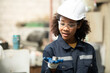 © Wosunan - A young female engineer inspects and repairs parts of a robotic welding machine