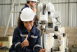 © Wosunan - The two engineers check the operation of welding robots. ready to transfer and exchange experiences each other's skills
