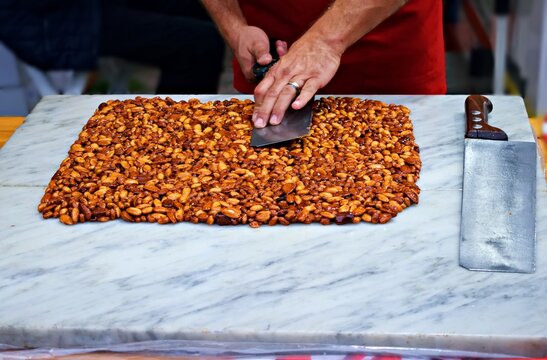 artisanal preparation of crunchy almonds, a typical Italian sweet made with caramelized sugar and almonds