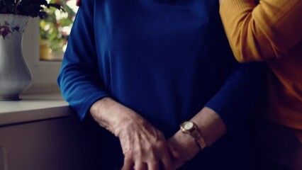 Poster - Senior woman holding hands and being consoled by younger woman
