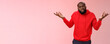 Bothered pissed african american bearded boyfriend in red hoodie arguing standing questioned bothered stupid accusations shrugging raise hands dismay cringing perplexed, pink background
