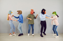 Group Of Five Strange People In Animal Disguise Dancing And Having Fun Together. Team Of Young Men And Women Wearing Funny Wacky Animal Masks Having Fun At Crazy Party