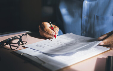 Wall Mural - Close-up view on desk office, businessman reading a contract of investment or insurance, legal agreement before signing, Starting successful partnership with entrepreneur or companie