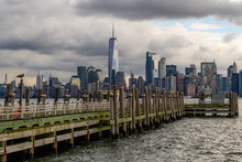Pier At The Liberty Island With Seagulls And Downtown Of Manhattan In The Background.