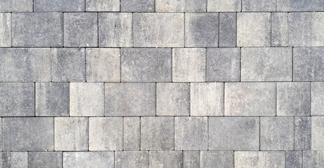 Gray paving stones. Paving surface road. Texture made of big gray cement bricks. Brick stone street road - pavement texture effect