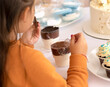 cute girl eating dessert. little sweet tooth overeats sweets. Concept to depend in children on white sugar. High quality photo