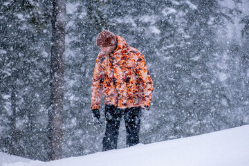 A man is drowning in snowdrifts. Snowstorm in the middle of the forest