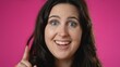 © Robert Peak - Closeup portrait of thinking, smart puzzled pensive young hipster woman 20s looks around thinks comes up with great idea raised finger isolated on pink background studio