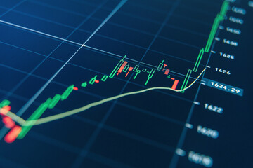 Tools for crypto currency investments analysis. Graph of digital money price movements represented with green and red candlesticks, time intervals and volumes on blue display. 