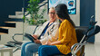 © DC Studio - Female doctor taking notes on tablet at consultation with asian patient suffering from physical disability. Person with crutches talking to medic at checkup examination appointment.