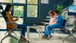 © DC Studio - Elderly asian patient writing medical checkup report in waiting area, nurse helping woman to fill in appointment form papers. Preparing to attend examination with specialist. Tripod shot.