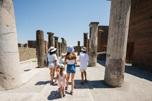 Back Of Family Tourist Walking At Pompeii Ancient City, Italy.