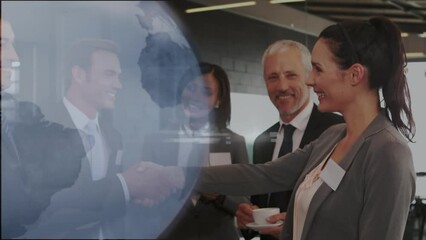 Sticker - Animation of globe icon over caucasian businessman and businesswoman shaking hands at office