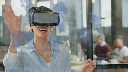 Canvas Print - Animation of digital icons and data processing over caucasian woman wearing vr headset at office