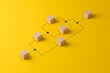 © Monster Ztudio - Business process and workflow automation with flowchart. Wooden cube block arranging processing management on yellow background. 3d render illustration