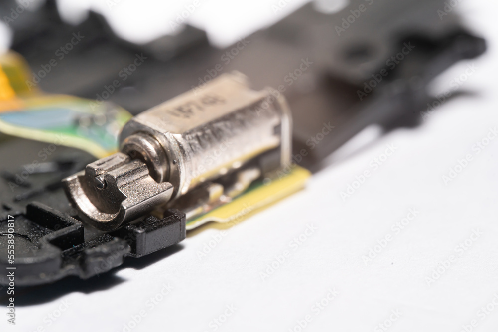 Stock-Foto „Motor that generates vibration to the mobile phone. vibration  in smartphone. vibration motor in Smartphone. vibration component on  smartphone.“