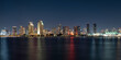 San Diego City Skyline Nightscape Series, downtown skyscraper buildings and illuminated reflections on the seawater in Southern California, USA, view from Coronado Island Ferry Landing Pier