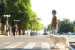 © Pixel-Shot - Blind senior man crossing road with guide dog in city