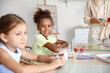 © Pixel-Shot - Little African-American girl in workshop for Ebru painting