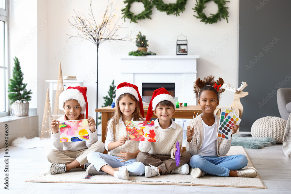 Little children with Ebru paintings at workshop on Christmas eve