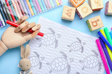 Sticker - Coloring page, felt-tip pens, pencils, wooden hand and toys on blue background