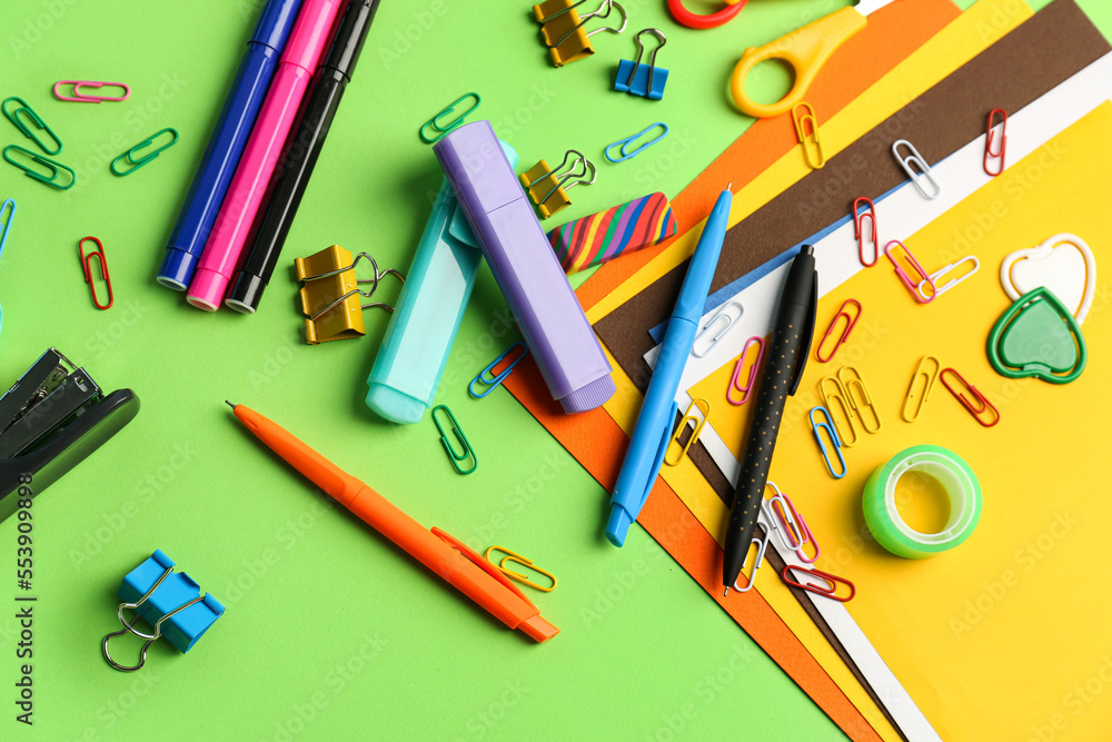 Set of different stationery on green background