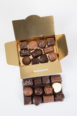 Wall Mural - golden box assortment many small square fine chocolate candies milk dark in gift square open gold carton