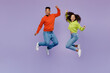 © ViDi Studio - Full body side view overjoyed young couple two friends family man woman of African American ethnicity wear casual clothes together do winner gesture isolated on pastel plain light purple background.