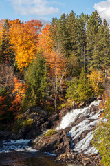 Wall Mural - Waterfall and trees with fall colors at Montagne d'argent. Quebec. Canada.