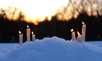 Poster - Burning candles on snow, beautiful evening winter natural background. magic scene. Christmas, Yule sabbat, New Year Holidays concept. witchcraft ritual